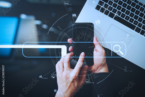 cyber security internet and networking concept.Businessman hand working with VR screen padlock icon mobile phone on computer background