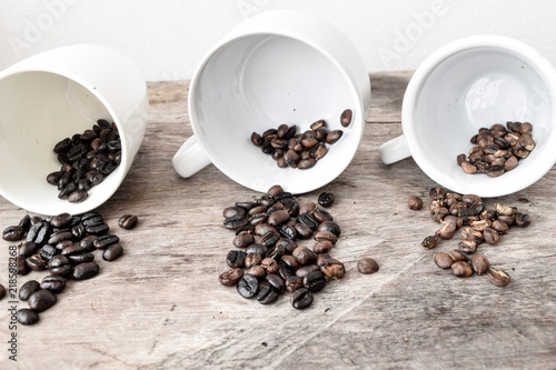Roasted coffee beans of three different level in black bow on grunge wooden background,Coffee bean 3 level roast