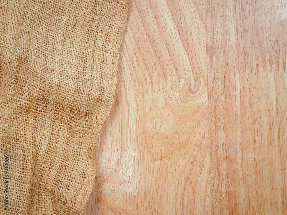 Naklejka premium texture background Wood table with old sackcloth burlap tablecloth