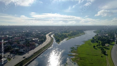 flight over city on river bank photo