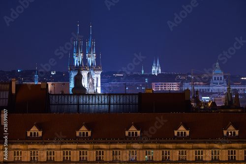 Night landscape, city scape picture of old town in Prague from bank of Vltava, Moldau river to Old square with towers of Tynsky temple, combination historic architecture photo