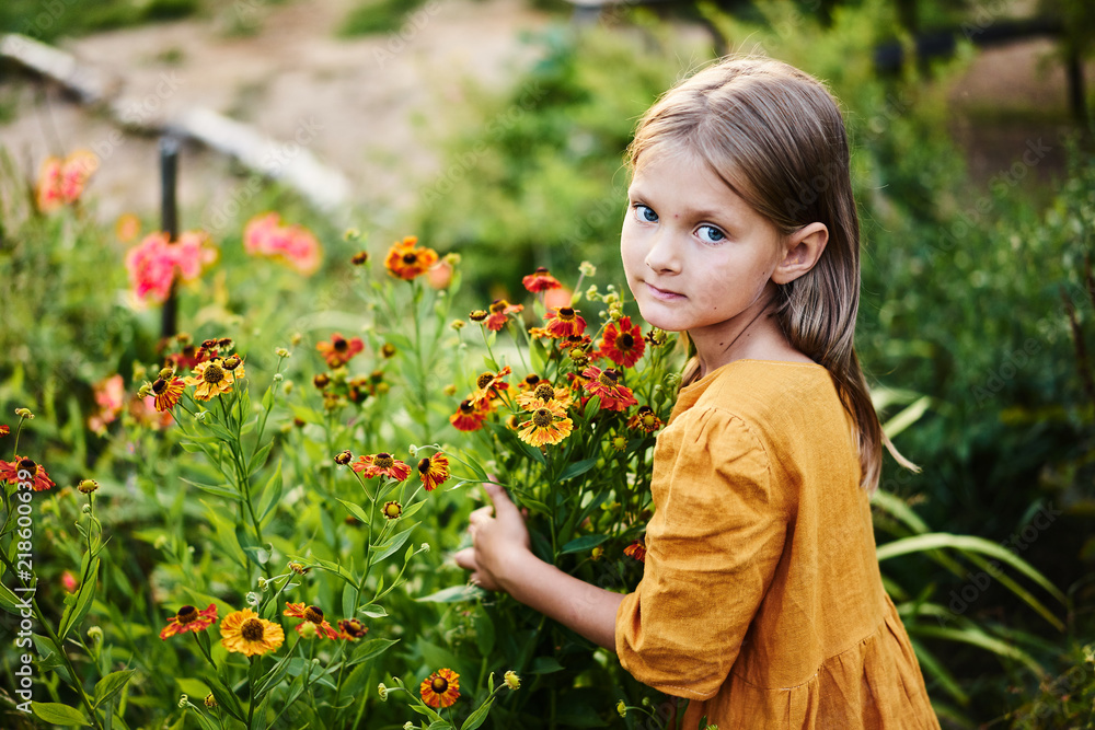 Little girl hold warm flowers watching Little girl hold warm flowers watching