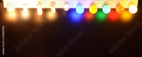 Colorful illumination on dark background. Multicolored bright lamps closeup