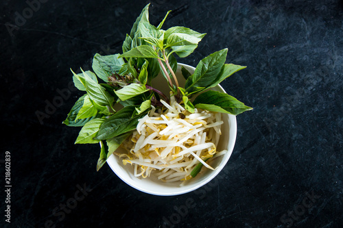 Bean Sprouts and Thai Herb on a bowl for Mixing Thai Noodle Soup photo