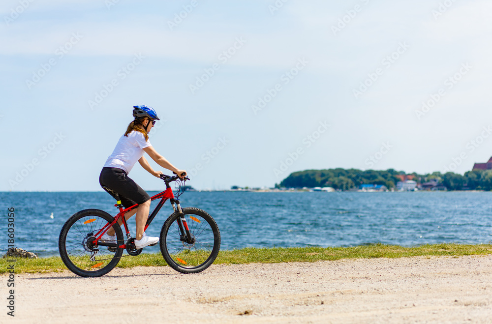 Healthy lifestyle - middle-aged woman riding bicycles Healthy lifestyle - middle-aged woman riding bicycles