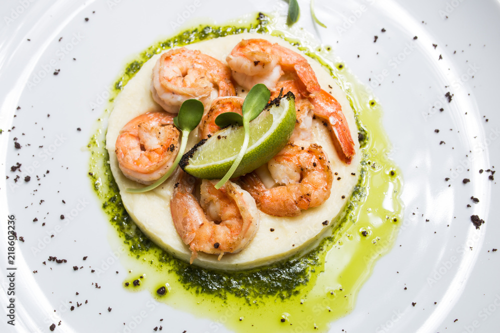 Shrimp with lime on a white plate close-up Shrimp with lime on a white plate close-up