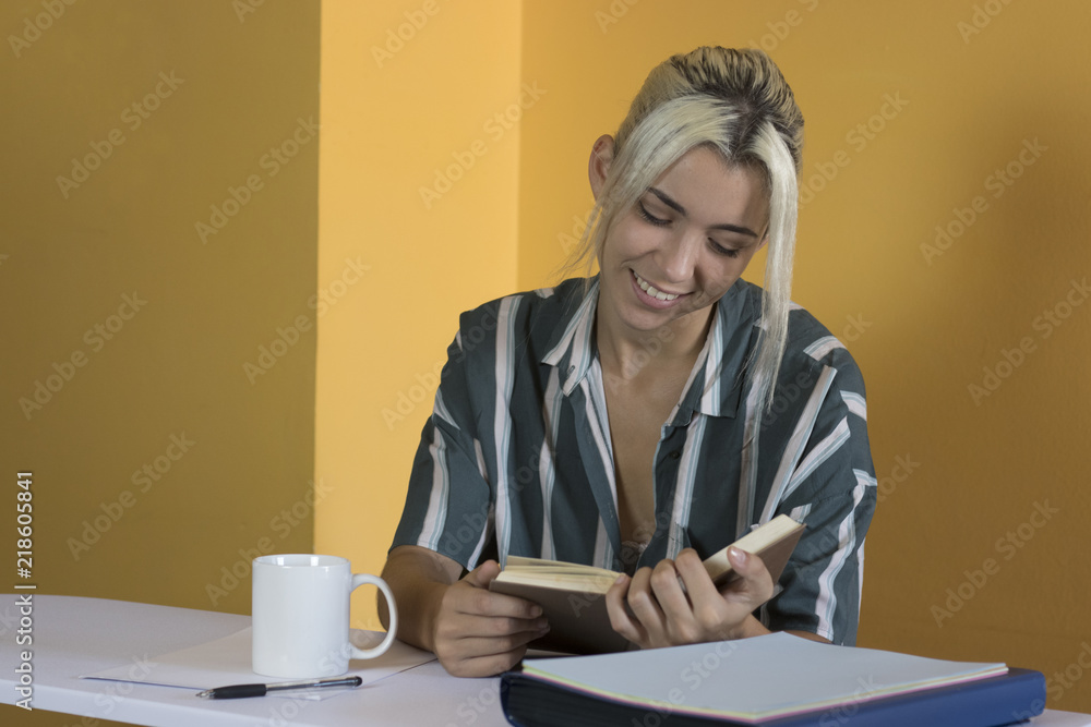 Woman reading a book in the office Woman reading a book in the office