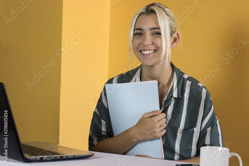 Office worker poses looking at camera photo