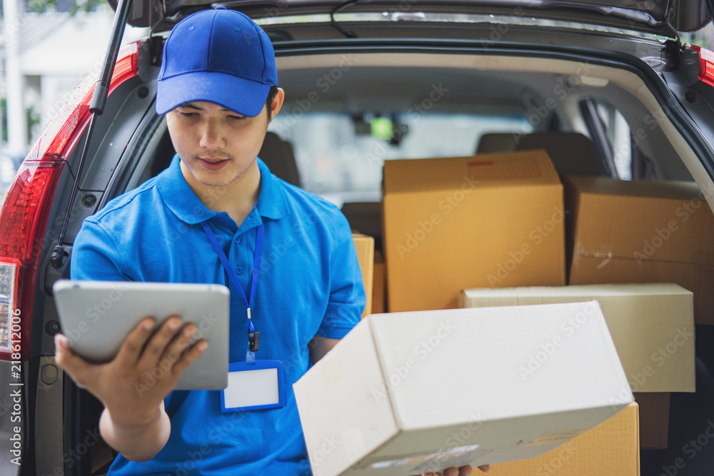 Delivery man checking list on tablet. Delivery man checking list on tablet.
