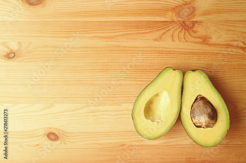 Top View of Ripe Avocados Fruit Cut In Half Isolated on Wooden background with Free Space for Text and Design 
