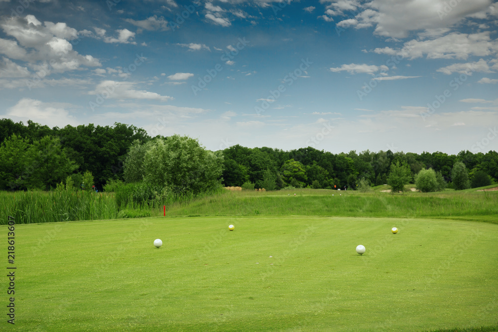 Four color balls on golf course, launching pad Four color balls on golf course, launching pad