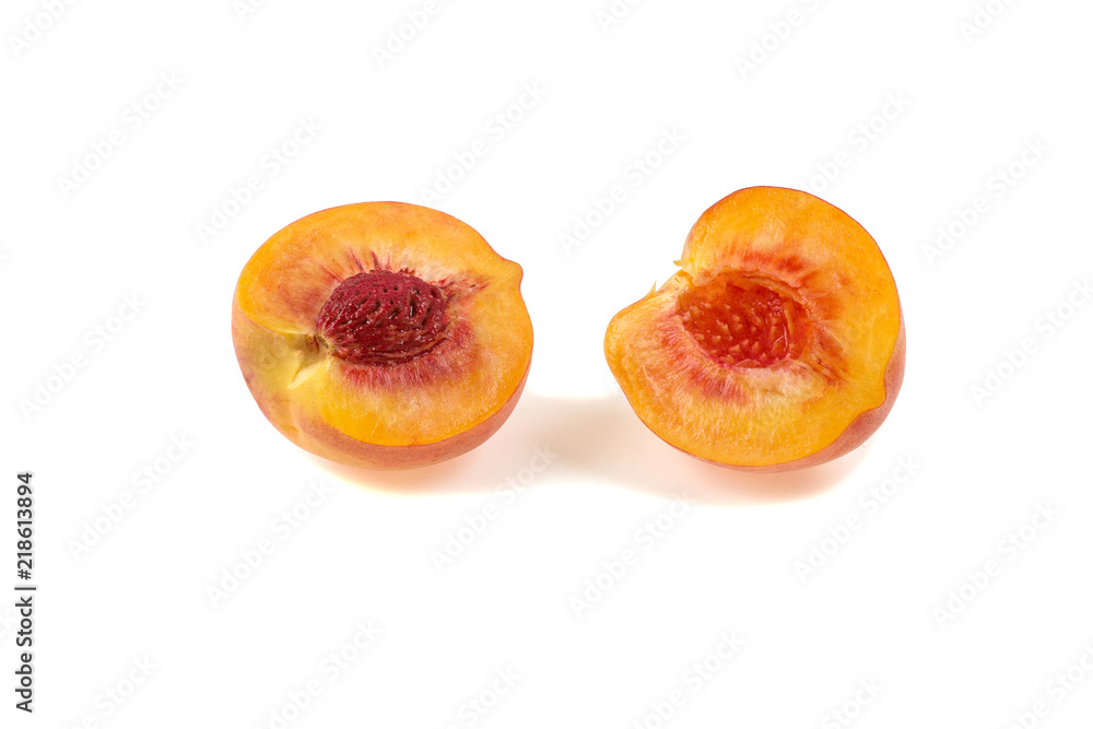 ripe juicy peach cut in half isolated on a white background