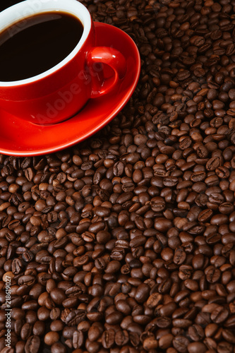 Red coffee cup with coffee beans .