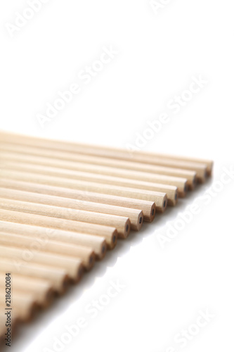 A couple of wooden pencils stacked together.