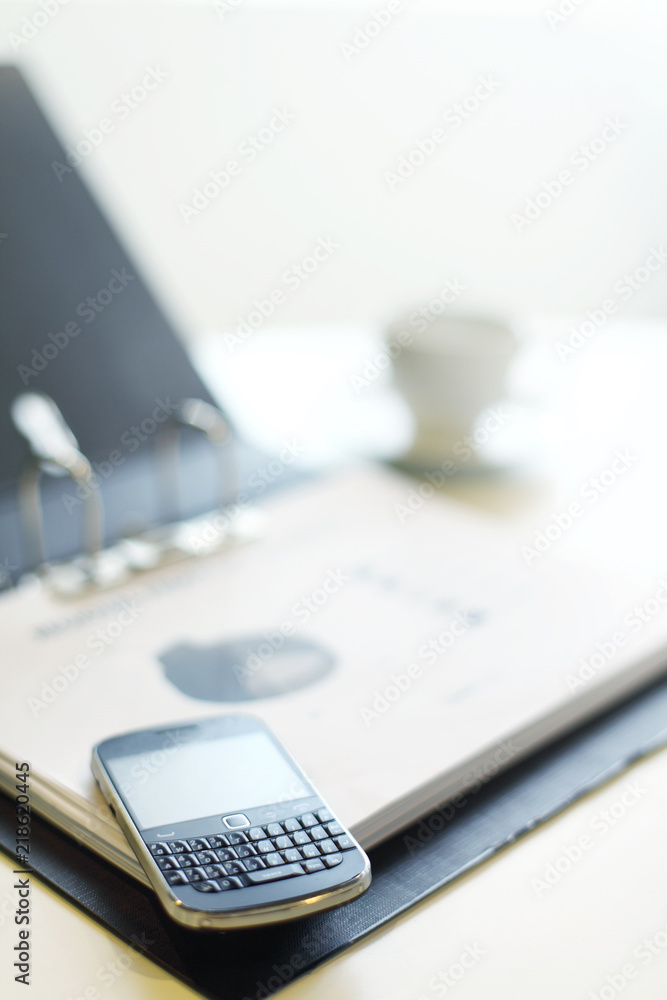Business concept shot with phone and chart on table Business concept shot with phone and chart on table