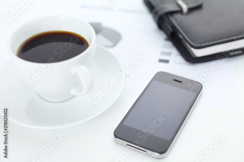 Business concept shot with coffee  phone and planner on table