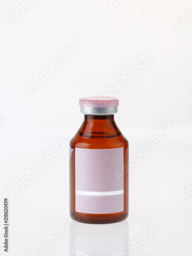 Small brown glass bottle on white background
