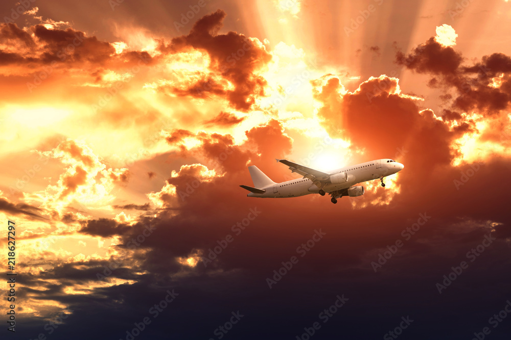 Airplane on the rainy cloudy sky background. The sun's rays make their way through the clouds. Airplane on the rainy cloudy sky background. The sun's rays make their way through the clouds.