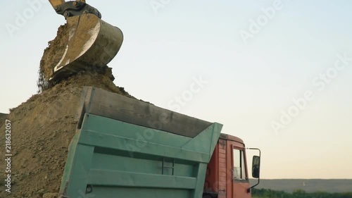 excavator loads a truck
