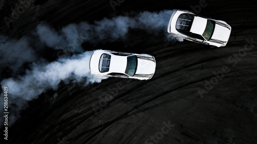 Aerial top view two cars drifting battle on asphalt race track, Two cars battle drift, Race cars view from above, Auto or automobile vehicle activity background concept.
