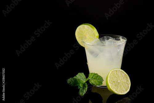 Lemon Drink with Fresh Mint, Ice Cold Summer drink isolated on black background