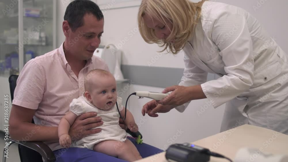 Nurse examines a baby Nurse examines a baby
