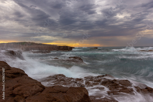 seascape Anna Bay beach in morning with sunrise sky and dramatic strom cloud