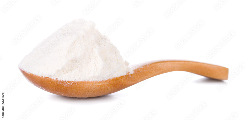 Wheat flour in wooden spoon isolated on white background Wheat flour in wooden spoon isolated on white background