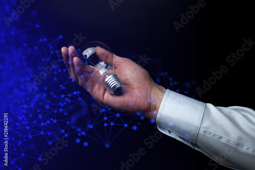 businessman hand hold the light bulb for network, power energy and business concept