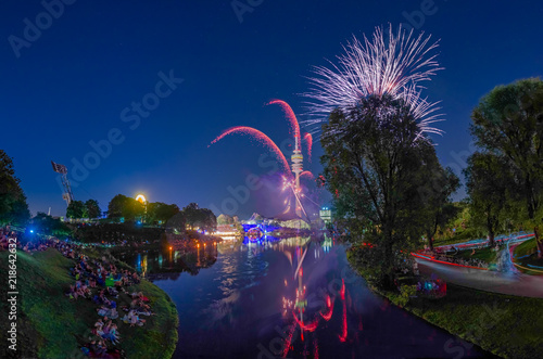 Das beeindruckende Feuerwerk des ImPark Festivals im Olympiapark von München mit farbenfrohen Explosionen der Feuerwerkskörper, die sich im See spiegeln