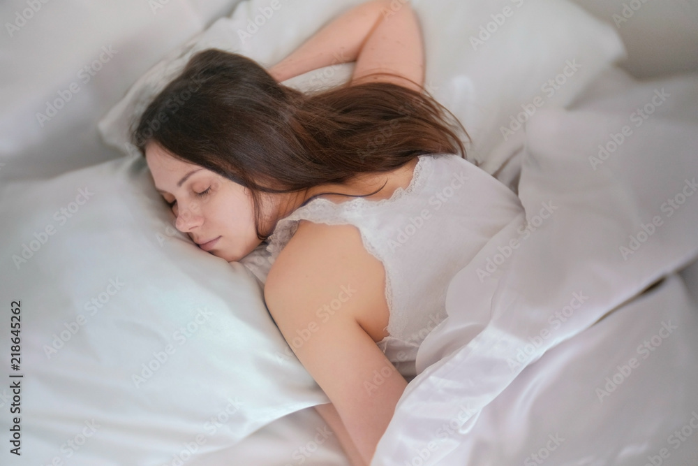 Young woman brunette sleeping in the bed. Young woman brunette sleeping in the bed.