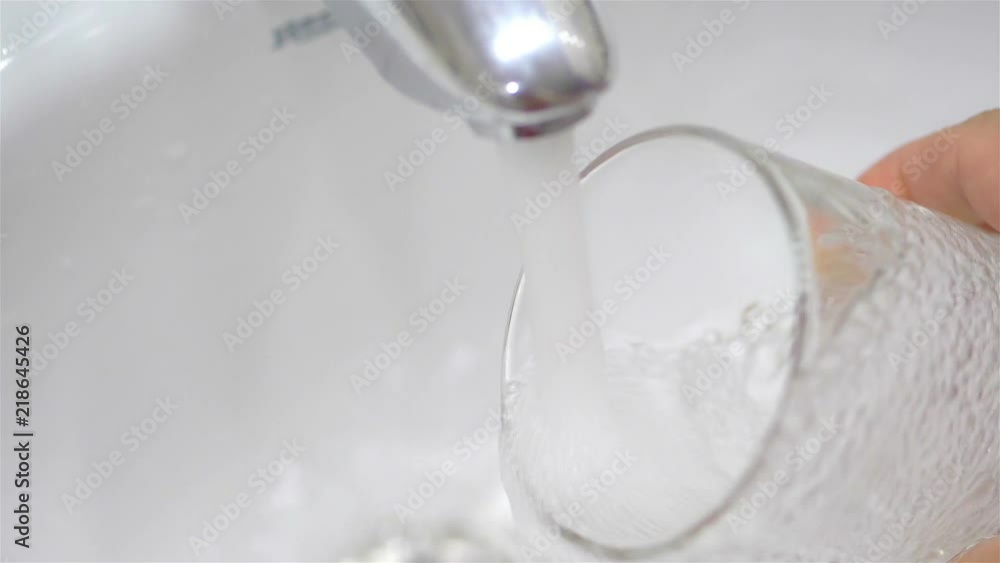 Filling glass with clean drinking water in slow motion 180fps Filling glass with clean drinking water in slow motion 180fps