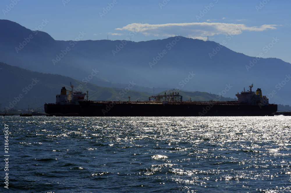 Ship in backlight, anchored at oil terminal Ship in backlight, anchored at oil terminal