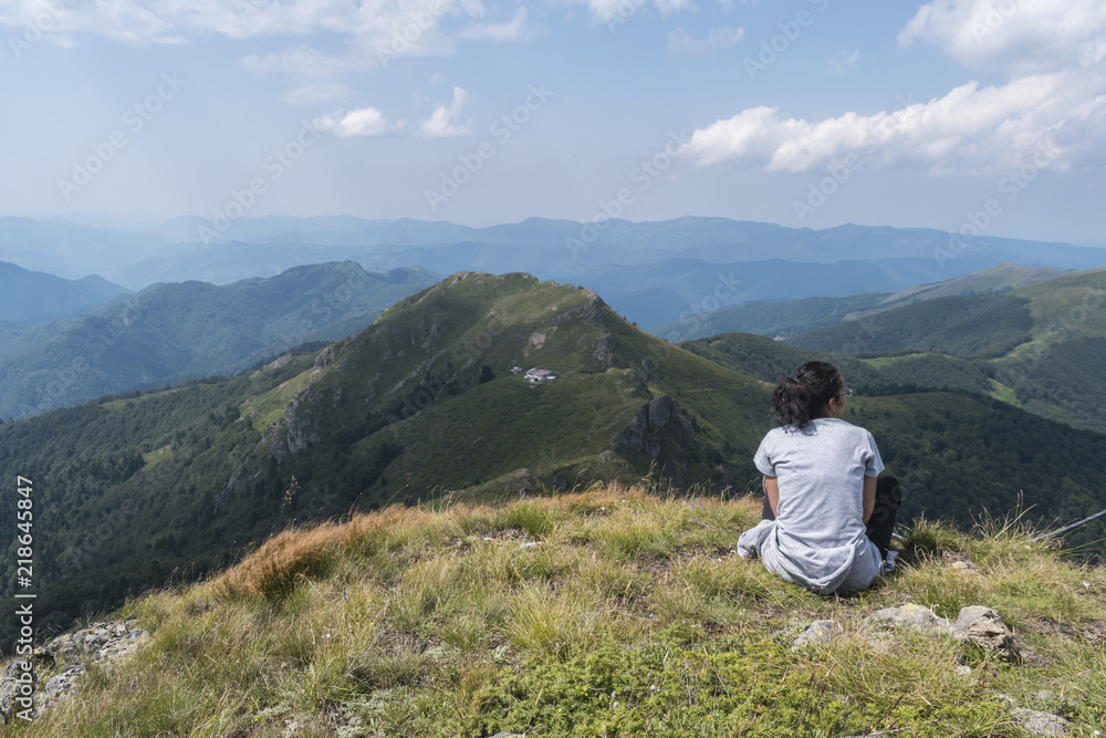 Beautiful girl in the mountains. An incredible view of the Troyan Balkan. The mountain captivates with its beauty, fresh air, a sense of infinity, coziness and tranquility.