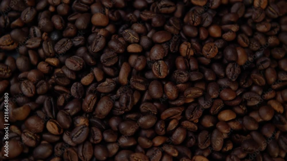Dark roasted beans rotate counter-clockwise, top view of the coffee background. Dark roasted beans rotate counter-clockwise, top view of the coffee background.