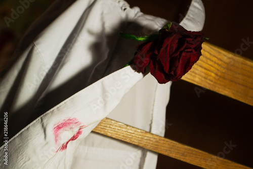 rose and lipstick on the shirt's collar