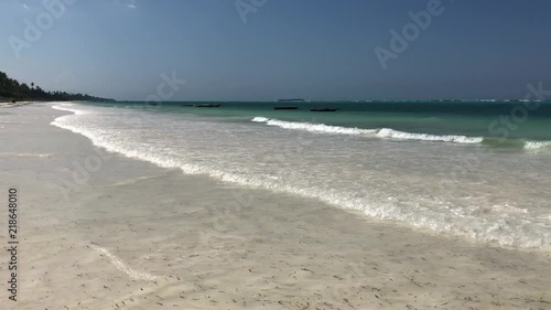 Tropical beach. Palms, sand, ocean, boats. Zanzibar. Tanzania