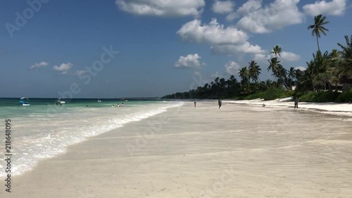 Zanzibar ocean beach. Palms, sand, people.