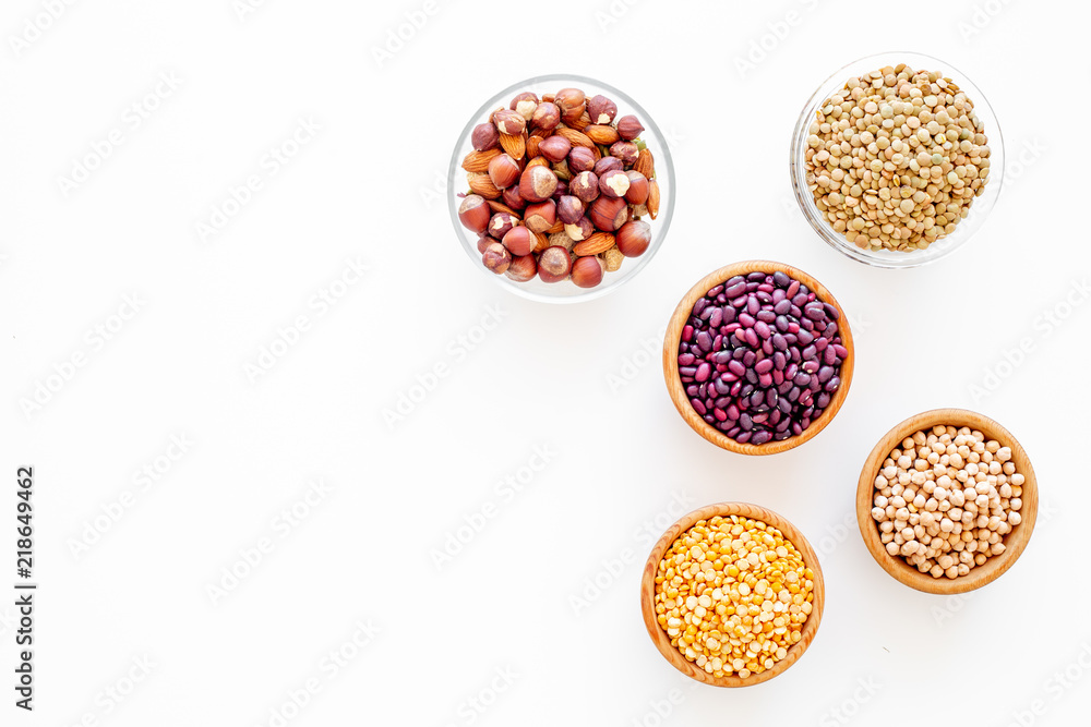 Vegan protein source. Legumes and nuts on white background top view copy space Vegan protein source. Legumes and nuts on white background top view copy space