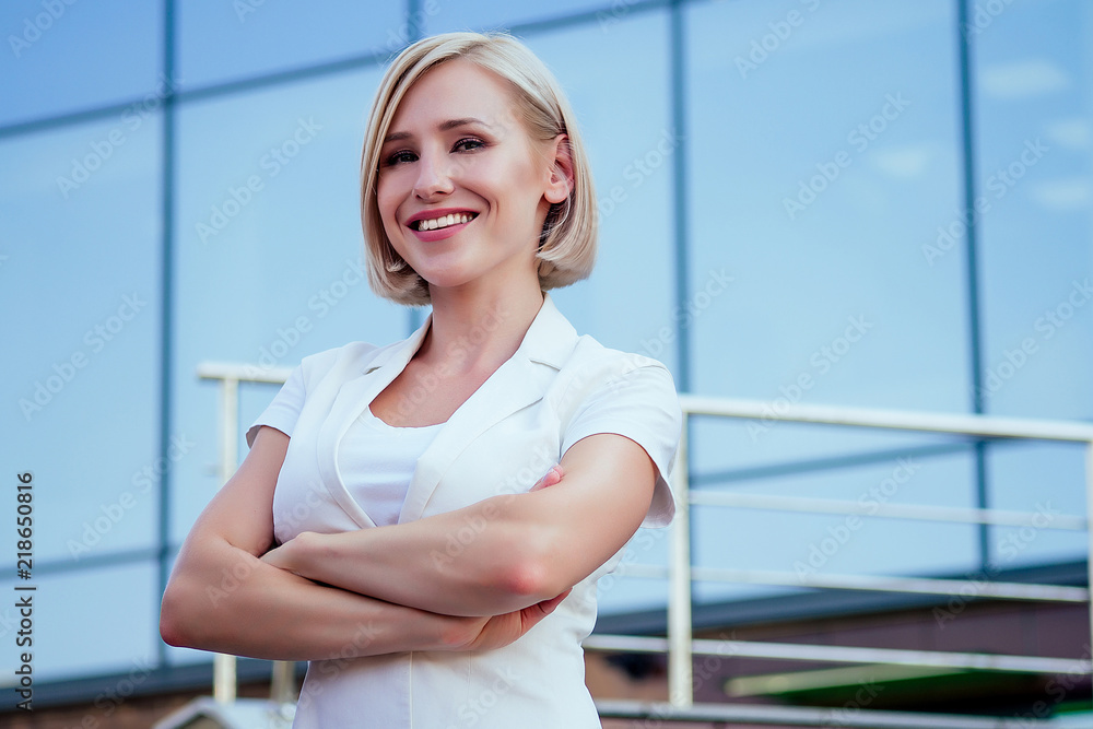 beautiful attractive blonde short haircut successful and independent woman business lady in a white jacket posing background of Manhattan glass offices cityscape beautiful attractive blonde short haircut successful and independent woman business lady in a white jacket posing background of Manhattan glass offices cityscape