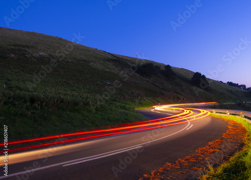 Car lights at night running on the road, Basque Country © poliki