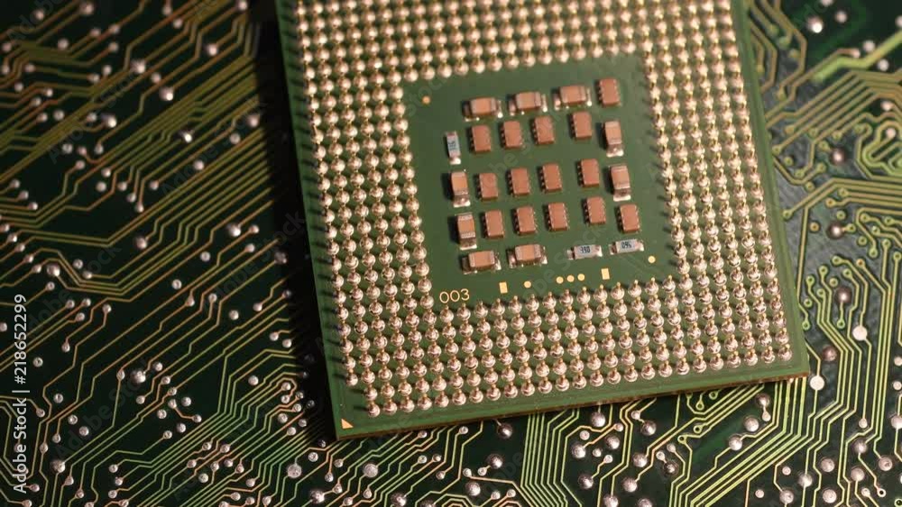 Close up of Computer Microprocessor over electronic green circuit board Close up of Computer Microprocessor over electronic green circuit board