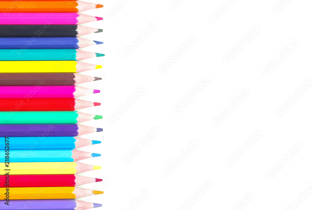 A lot of colored pencils lying in one line on a white background isolated A lot of colored pencils lying in one line on a white background isolated
