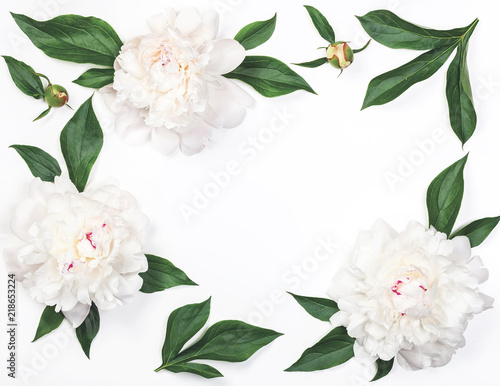Fototapeta Naklejka Na Ścianę i Meble -  Frame of white peony flowers and leaves isolated on white background. Top view. Flat lay.
