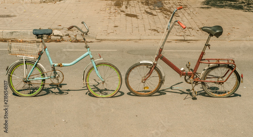 Two retro bicycles on the street, red and blue 