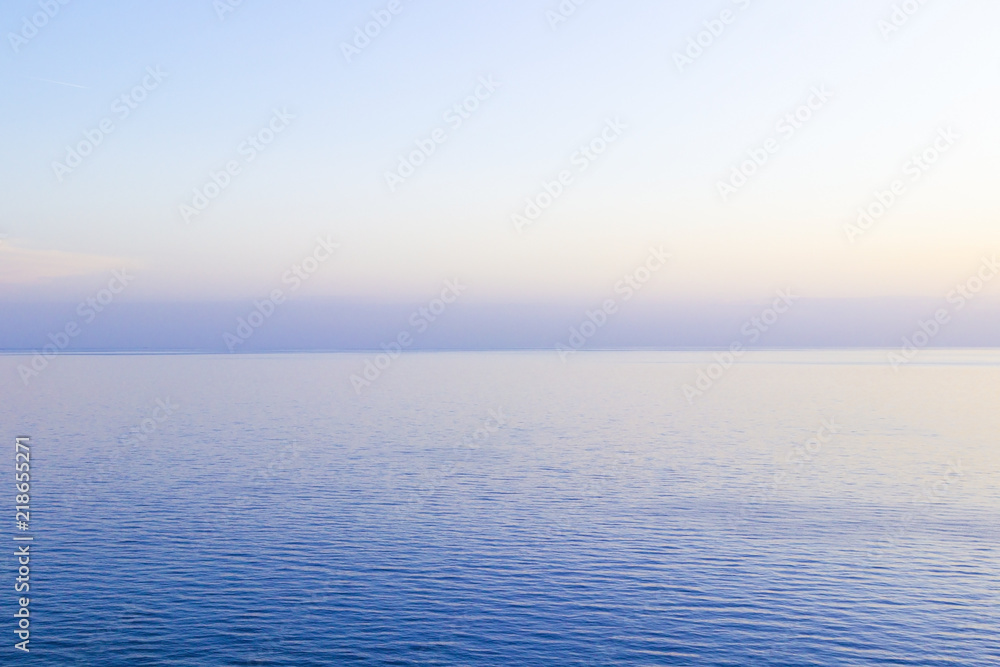 The sea at sunset, the sky in pastel colors.