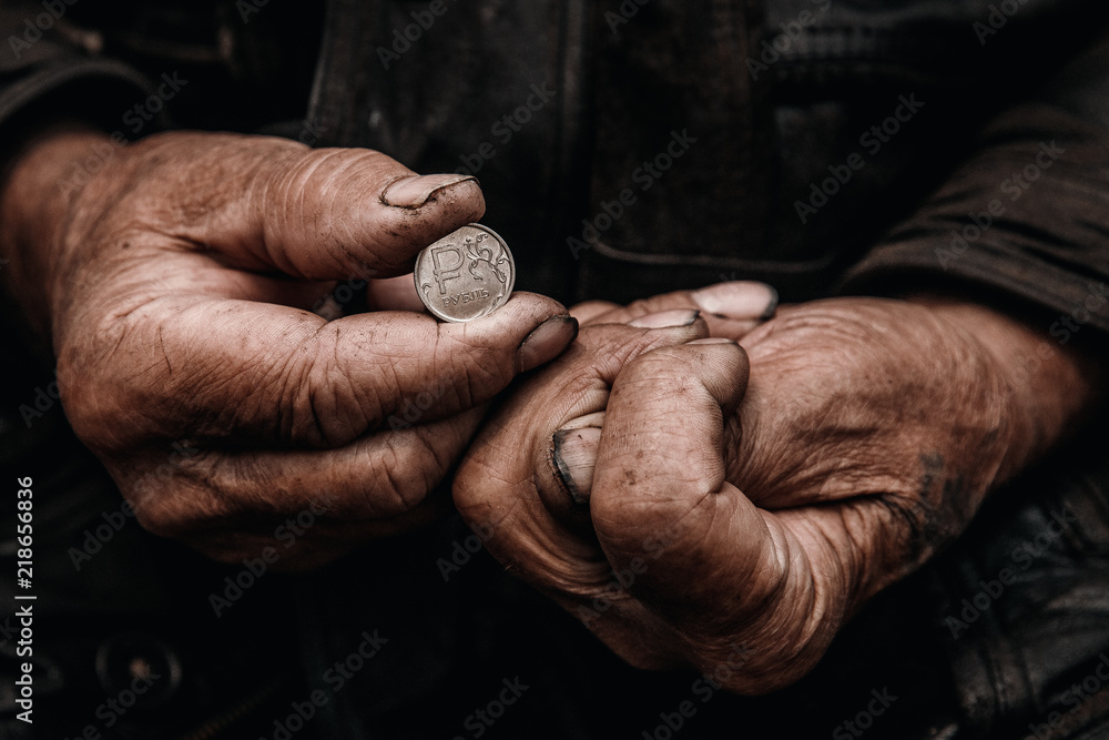 Concept Devaluation of ruble. Dirty hands old man poor with coin