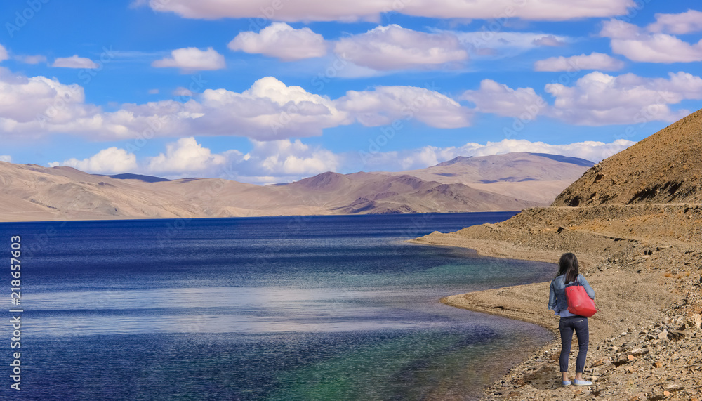 Female tourist enjoy the scenic view at TSO Moriri lake Ladakh India.