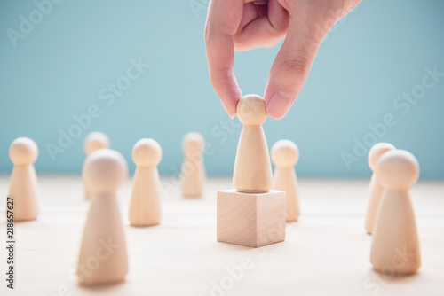 Successful team leader, Businessman hand choose people standing out from the crowd. photo