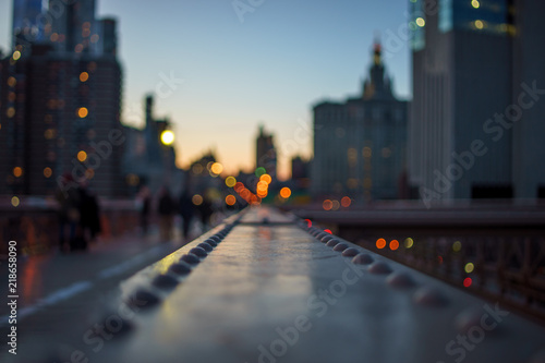 blurred Night lights of the New York with metal part of bridge foreground